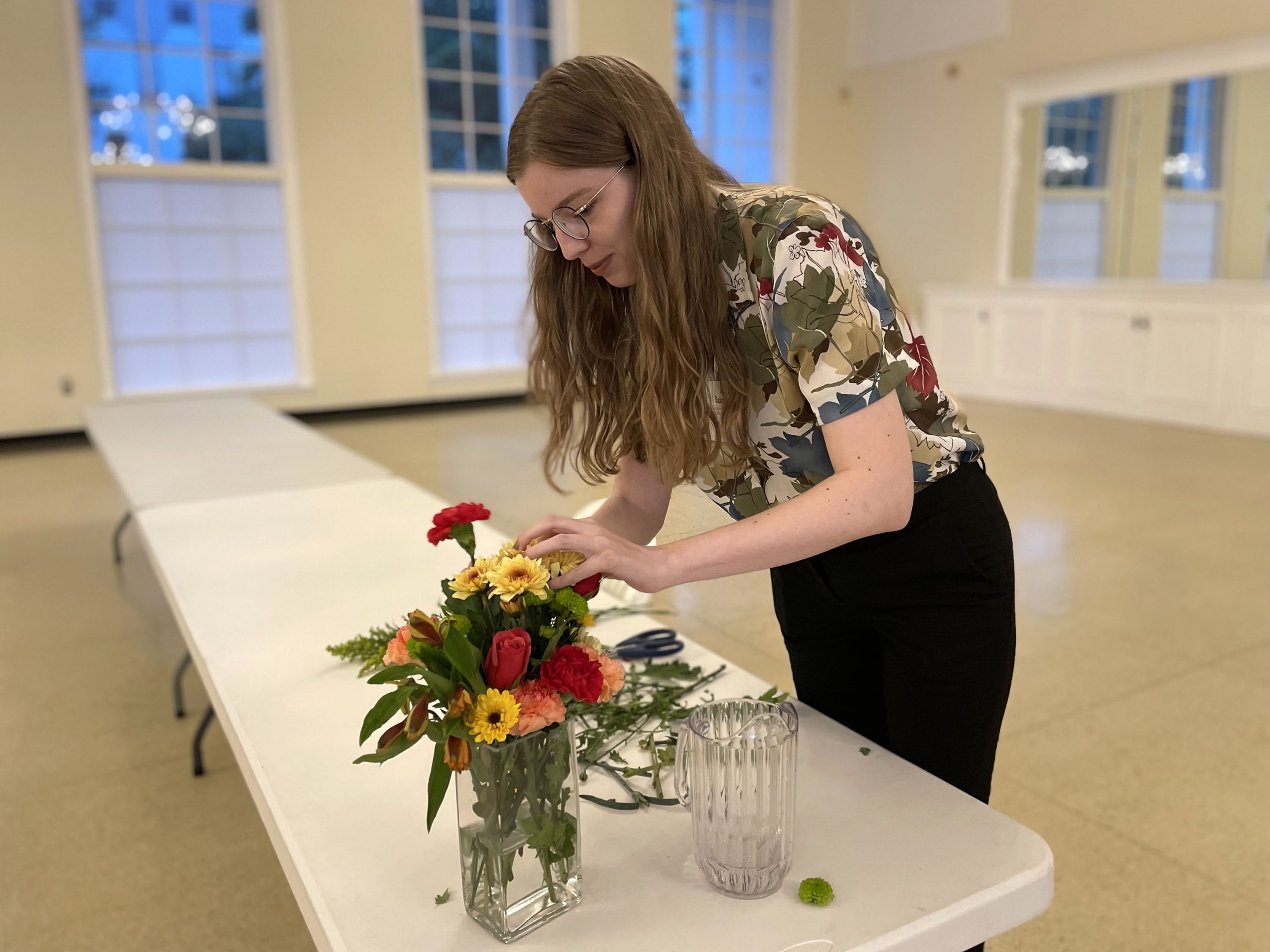 A guest places flowers in a vase